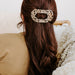 https://cdn.shopify.com/s/files/1/0065/8459/8593/products/blonde-tortoise-large-flat-round-clip-large-hair-clip-895634.jpg?v=1707232704