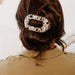 https://cdn.shopify.com/s/files/1/0065/8459/8593/products/blonde-tortoise-medium-flat-round-clip-medium-hair-clip-467689.jpg?v=1707232704