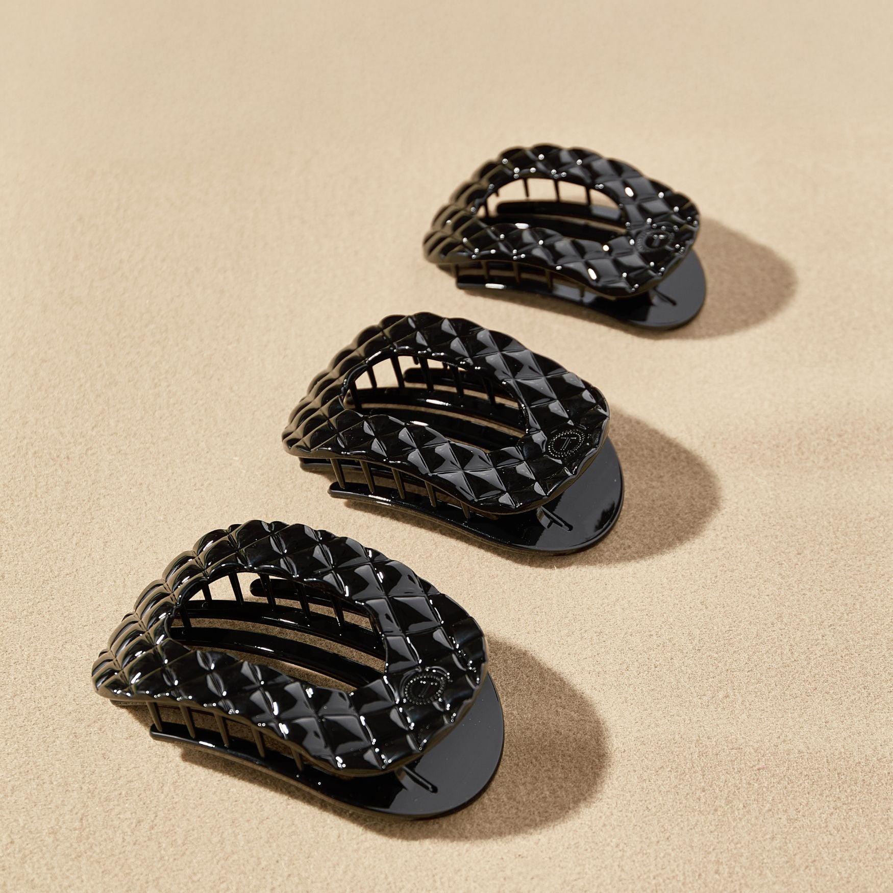 https://cdn.shopify.com/s/files/1/0065/8459/8593/files/jet-black-quilted-large-flat-round-hair-clip-hair-clips-9471776.jpg?v=1752708702