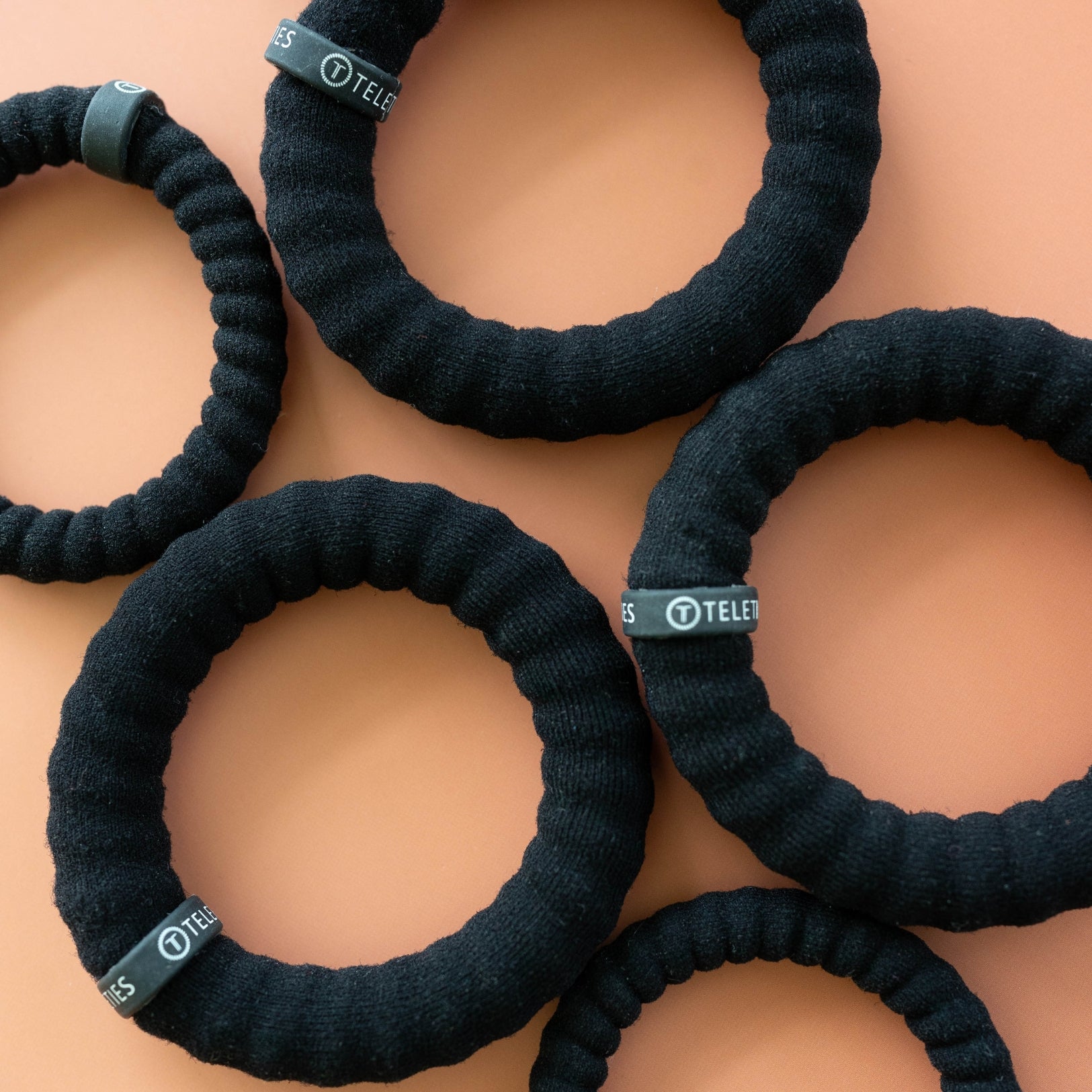 https://cdn.shopify.com/s/files/1/0065/8459/8593/files/jet-black-small-nylon-hair-ties-hair-ties-9255186.jpg?v=1758096625