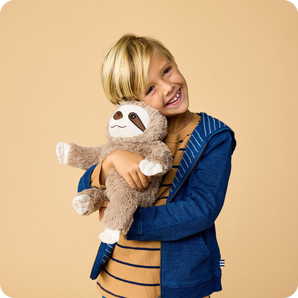 https://cdn.shopify.com/s/files/1/0284/0680/8664/files/sloth_5_warmies_lifestyle.jpg?v=1768427184
